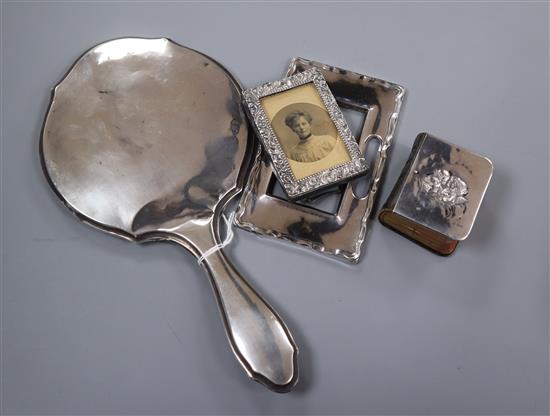 An Edwardian silver mounted small photograph frame, Birmingham, 1903 and three other silver items including hand mirror.